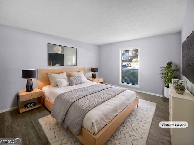 bedroom with dark hardwood / wood-style flooring