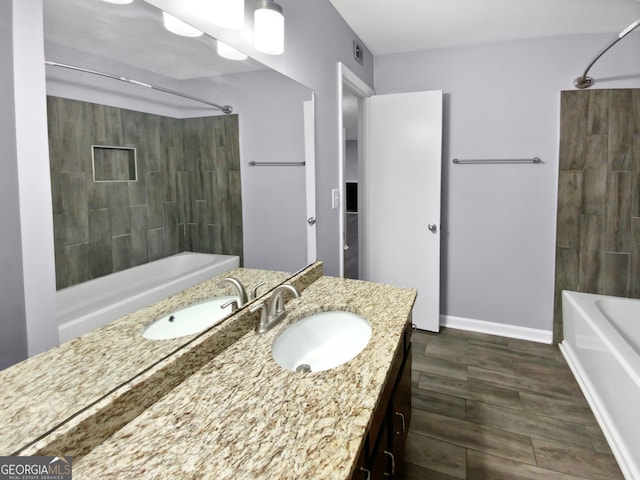 bathroom featuring vanity, tiled shower / bath combo, and hardwood / wood-style floors