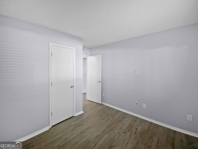 empty room with dark hardwood / wood-style floors