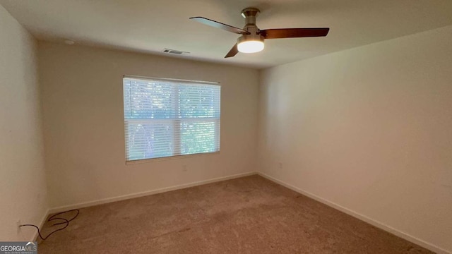 carpeted empty room featuring ceiling fan