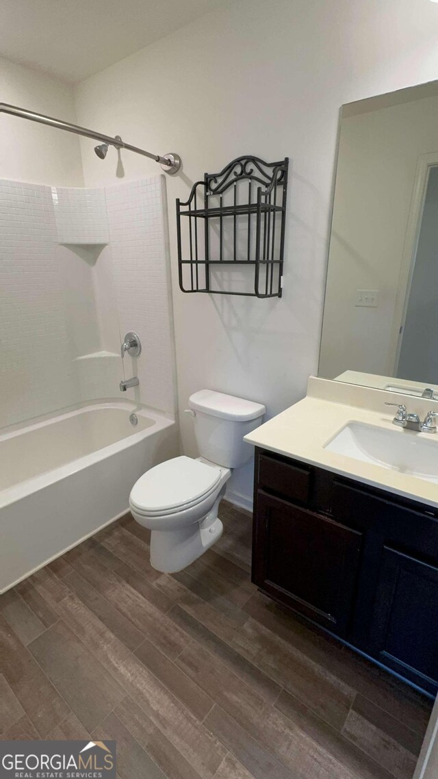 full bathroom featuring vanity, hardwood / wood-style floors, toilet, and tub / shower combination