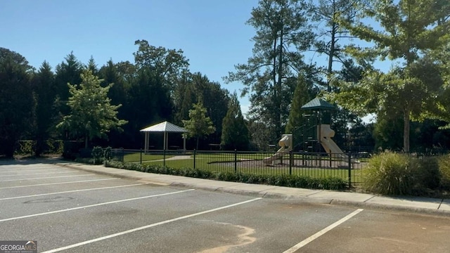 view of parking featuring a gazebo and a playground