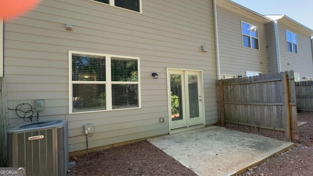 rear view of property featuring central air condition unit and a patio area