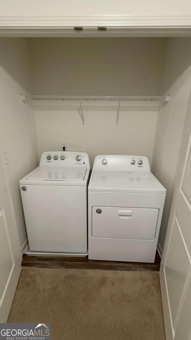 clothes washing area featuring independent washer and dryer and dark colored carpet