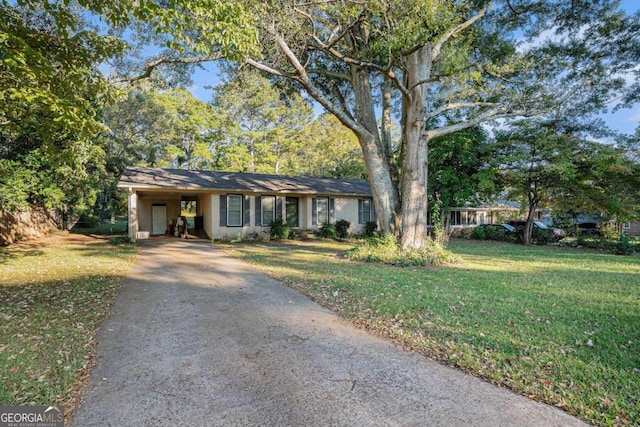 ranch-style house with a carport and a front lawn