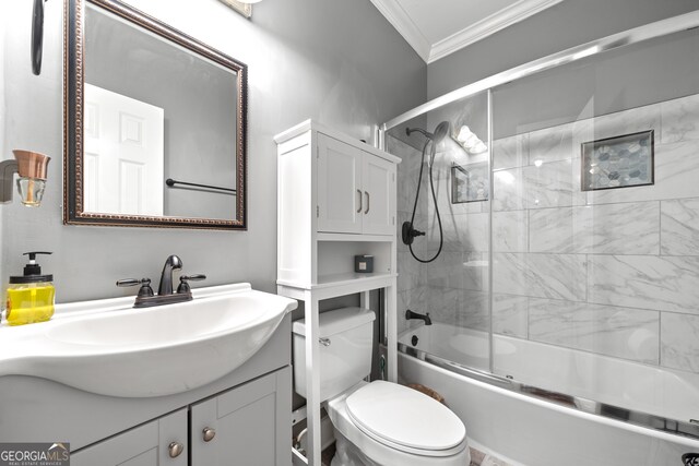 full bathroom with vanity, enclosed tub / shower combo, ornamental molding, and toilet