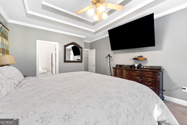 carpeted bedroom with ceiling fan, crown molding, ensuite bathroom, and a raised ceiling