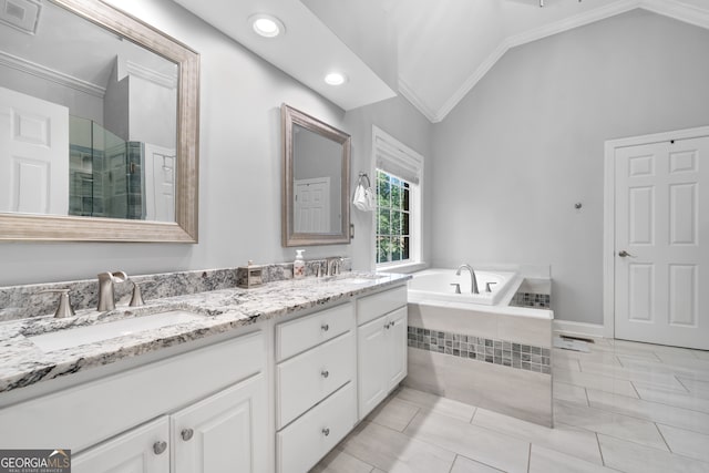 bathroom featuring vanity, crown molding, lofted ceiling, and shower with separate bathtub