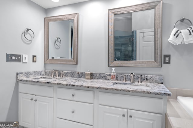 bathroom featuring vanity and shower with separate bathtub