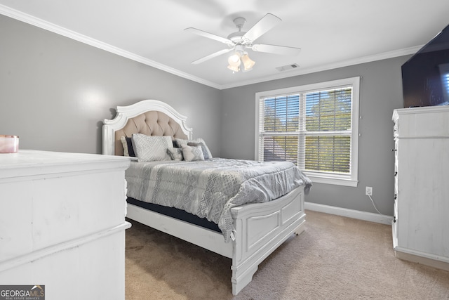 carpeted bedroom featuring ornamental molding and ceiling fan