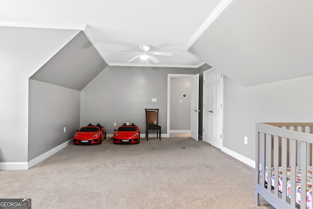 bedroom featuring ceiling fan, light carpet, vaulted ceiling, crown molding, and a nursery area