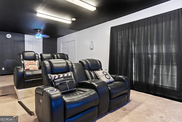 home theater room featuring ceiling fan and carpet floors