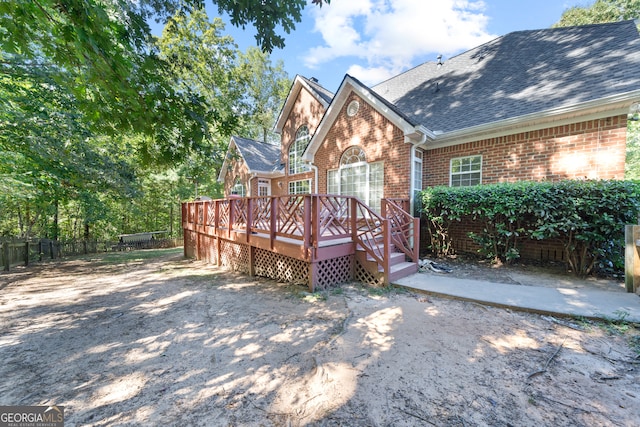 rear view of property featuring a deck