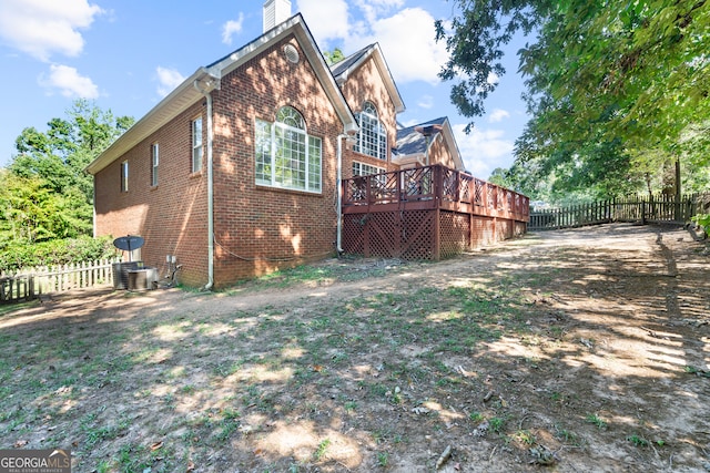 view of home's exterior featuring a wooden deck and central AC