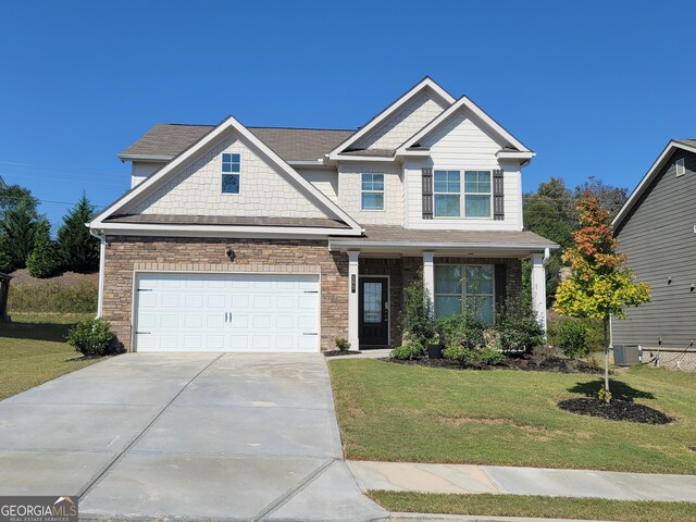 craftsman inspired home featuring central AC, a front lawn, and a garage