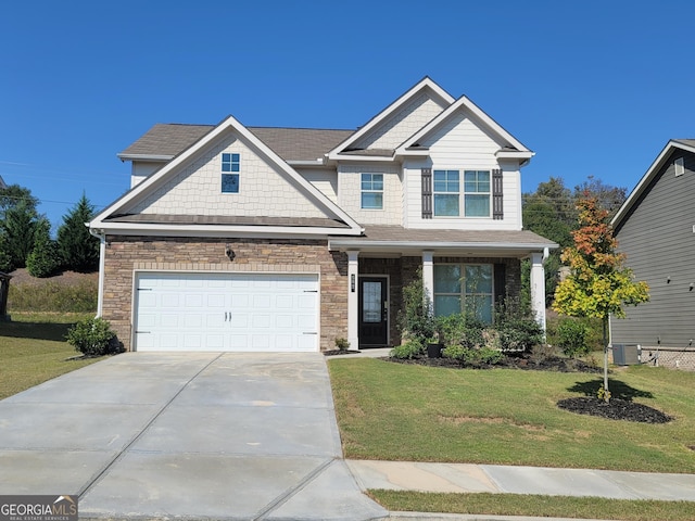 craftsman house with an attached garage, central AC, a front lawn, and concrete driveway