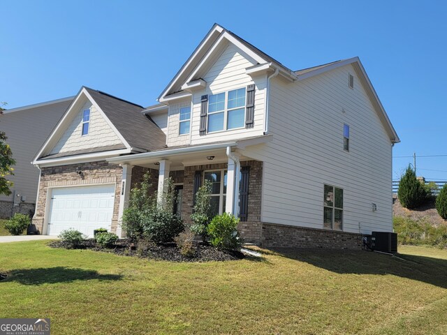 craftsman inspired home with central air condition unit, a front lawn, and a garage