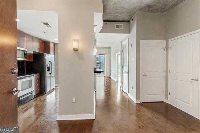 kitchen featuring appliances with stainless steel finishes and dark hardwood / wood-style flooring