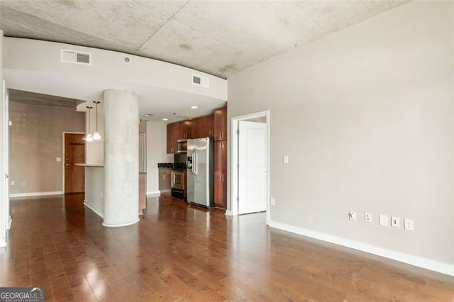 unfurnished living room with dark hardwood / wood-style floors