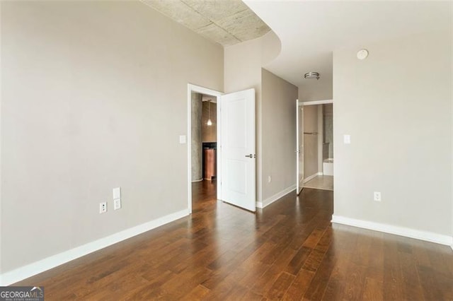 unfurnished room with dark hardwood / wood-style floors