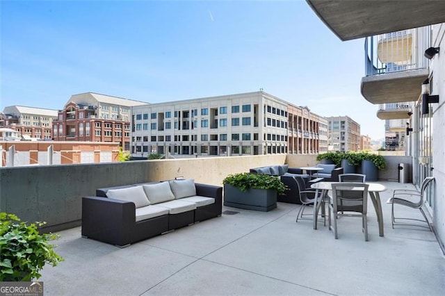 view of patio featuring an outdoor hangout area and a balcony