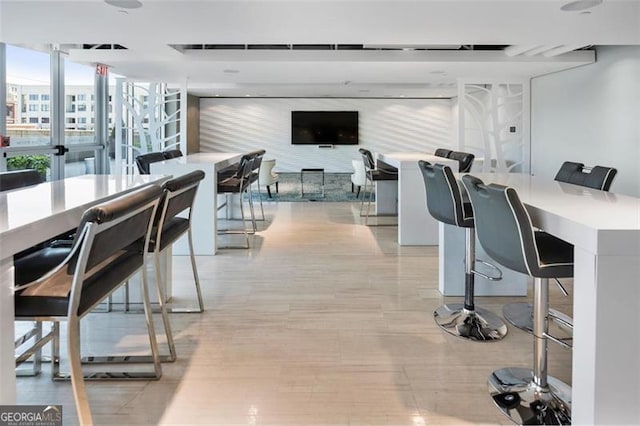 dining room featuring light hardwood / wood-style floors and expansive windows