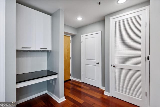 corridor featuring dark hardwood / wood-style floors