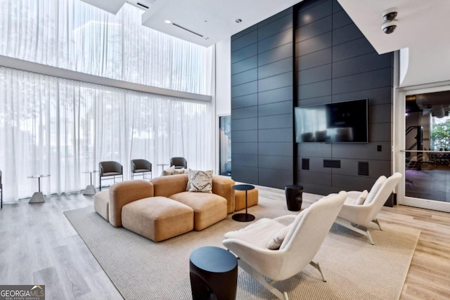 living room featuring a high ceiling and hardwood / wood-style floors