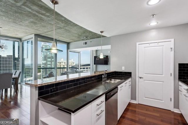 kitchen with kitchen peninsula, white cabinetry, dishwasher, dark hardwood / wood-style floors, and sink