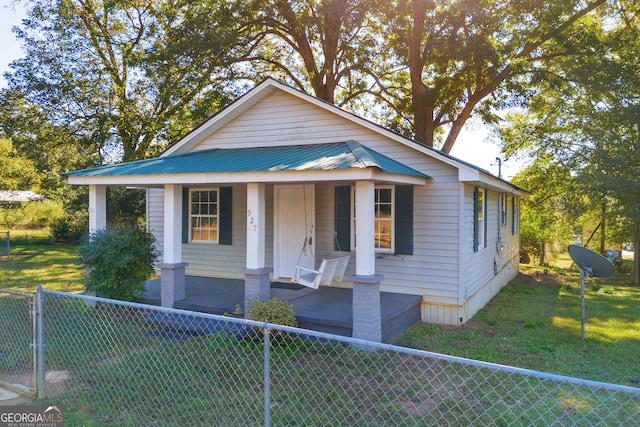 bungalow with a front yard and a porch