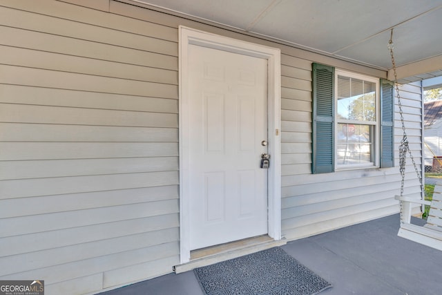 view of exterior entry with covered porch