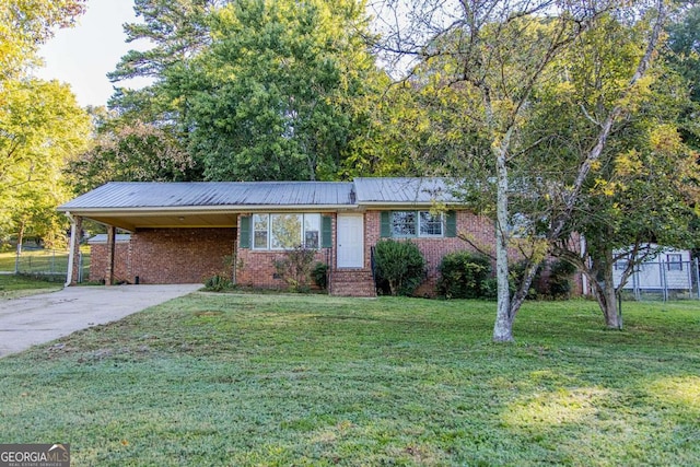 ranch-style house with a front yard and a carport