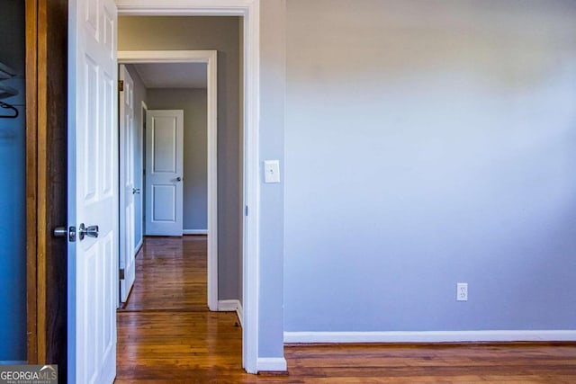 hallway with dark hardwood / wood-style floors