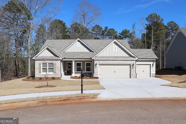 craftsman-style home featuring board and batten siding, concrete driveway, an attached garage, roof with shingles, and brick siding