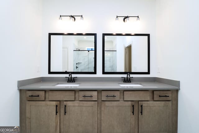 bathroom featuring a sink, a shower with door, and double vanity