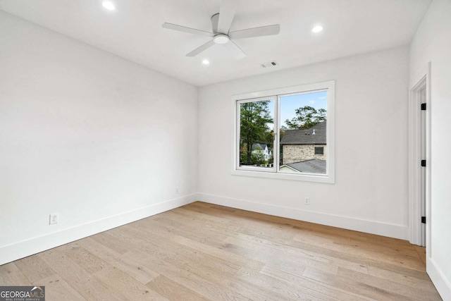 empty room featuring ceiling fan and light hardwood / wood-style floors