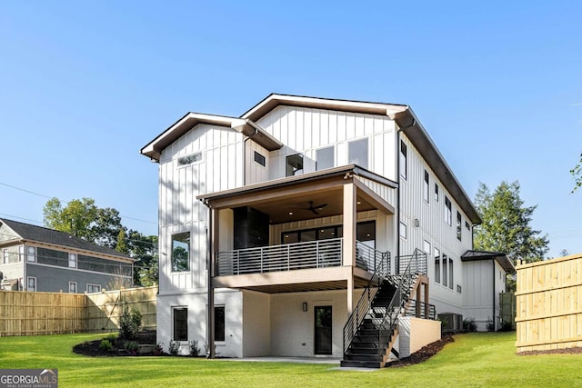 rear view of house with a lawn, ceiling fan, a balcony, and cooling unit