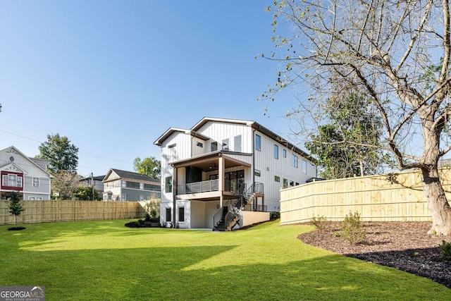 rear view of property with a lawn