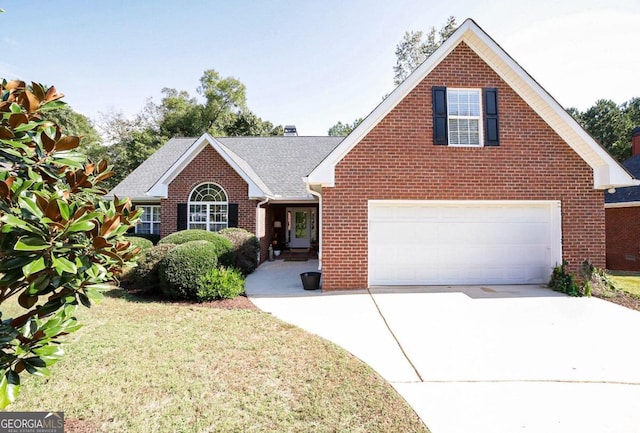 view of front of property featuring a garage and a front lawn