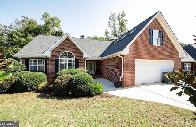 view of front of house featuring a front lawn and a garage