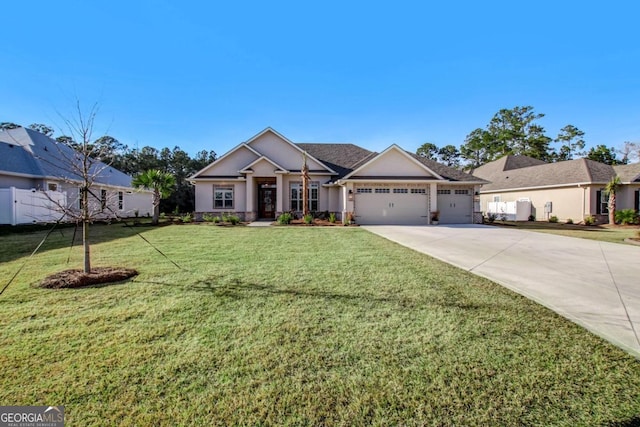 view of front of home featuring a front lawn and a garage