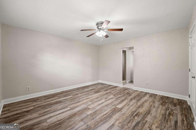 empty room featuring ceiling fan and hardwood / wood-style flooring