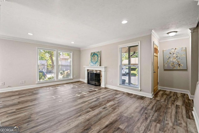 unfurnished living room featuring crown molding, a healthy amount of sunlight, a textured ceiling, and dark hardwood / wood-style floors