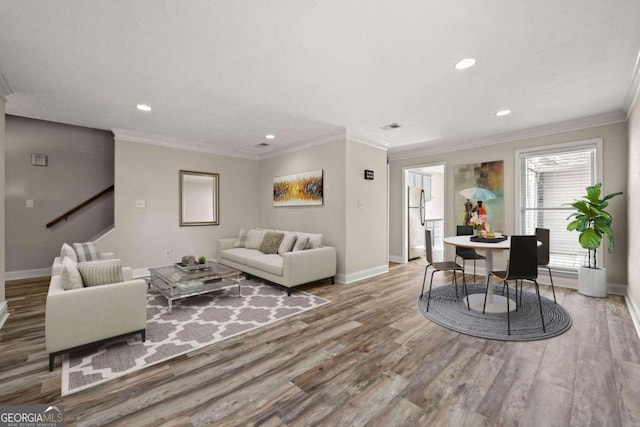 living room with ornamental molding and wood-type flooring