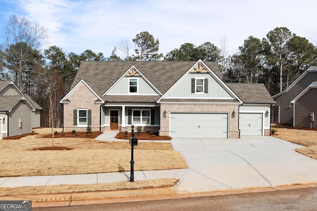 craftsman-style home with brick siding, board and batten siding, driveway, and a shingled roof