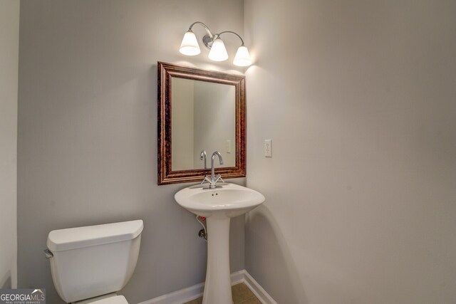 bathroom featuring toilet and tile patterned flooring