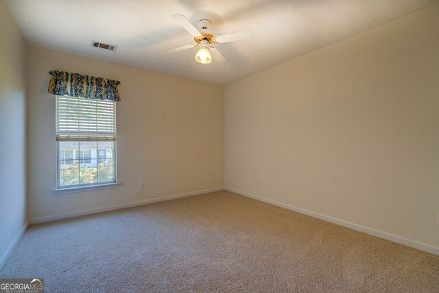 carpeted empty room with ceiling fan