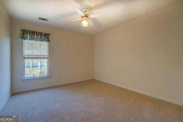 unfurnished room with light carpet, baseboards, and ceiling fan