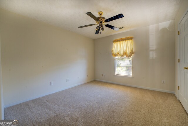 unfurnished room featuring light colored carpet and ceiling fan