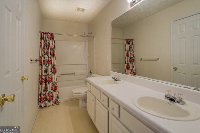 full bathroom featuring toilet, a textured ceiling, vanity, and shower / bath combination with curtain